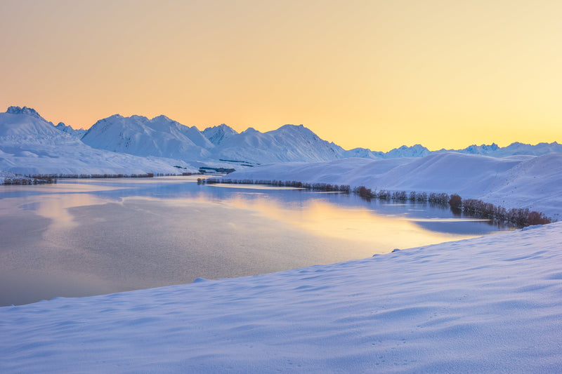 Fresh snow at dawn looking down on Lake Alexandrina towards the Godley Mountain Range, Mackenzie Country, New Zealand