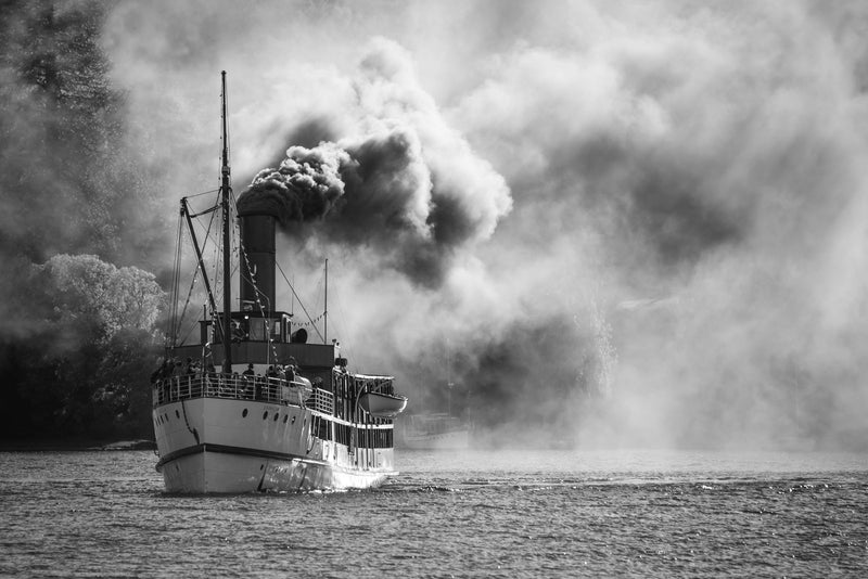 The TSS Earnslaw takes off on its 100th year celebration journey to Glenorchy with people dressed in period costume onboard. Shot taken in Queenstown Bay, Lake Wakatipu