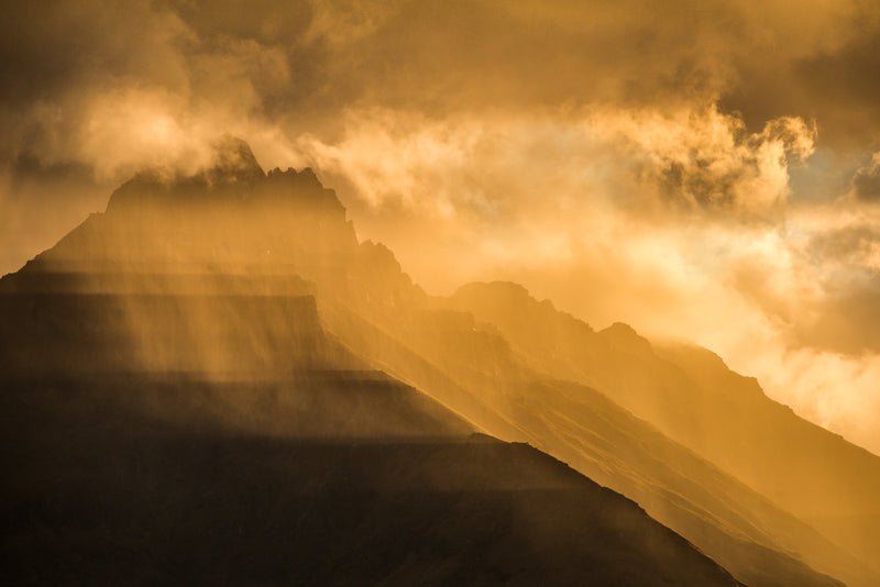 The last sunlight of the day casts shadows across Walter Peak as a perfectly timed rain squall passes by.
