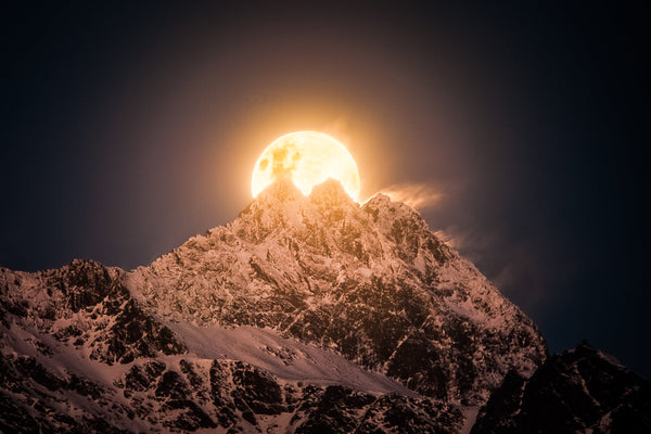 The strong winds blow moonlit whispers of fresh snow from the three peaks of the Remarkables Mountains near Queenstown.