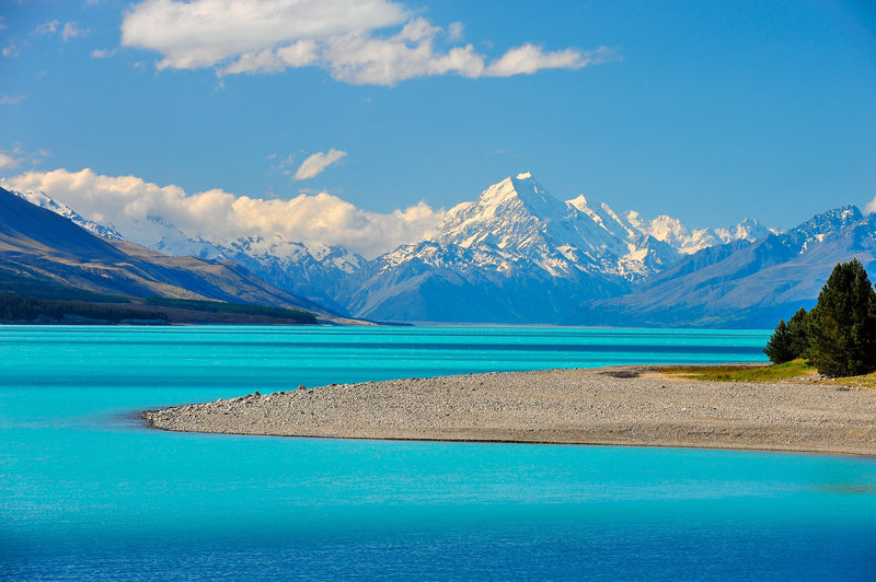 Aoraki Mt Cook lies at the head of Lake Pukaki. Shadows from the overhead clouds are cast on the glacial waters of Lake Pukaki in the Mackenzie Basin.