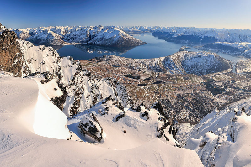 The view the day after a passing winters snowstorm, overlooking a calm Lake Wakatipu, Queenstown. Taken from high up on the Remarkables Mountain ridgeline.