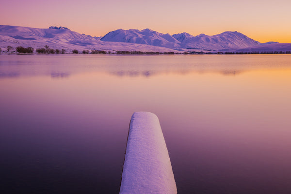 Fresh snow at dawn over looking Lake Alexandrina towards the Godley Mountain Range, Mackenzie Country, New Zealand